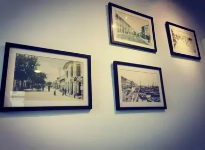a group of framed pictures on a wall at Barrington Square Apartment Pasar Malam in Brinchang