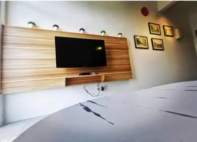 a living room with a flat screen tv on a wall at Barrington Square Apartment Pasar Malam in Brinchang