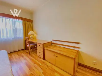 a bedroom with a desk and a bed and a desk and chair at Cozy Highlands Escape at Copthorne Cameron Highlands in Tanah Rata