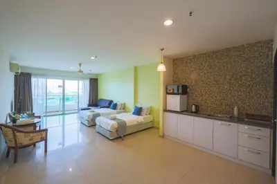 a kitchen and living room with a couch and a table at Marina Island Lumut Homestay in Lumut