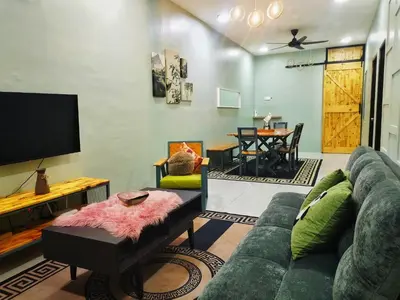 a living room with a couch and a table at D'mesyar Homestay 3BR Fully airconds in Teluk Intan