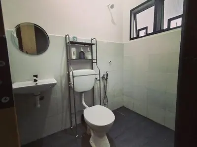 a bathroom with a toilet and a sink at D'mesyar Homestay 3BR Fully airconds in Teluk Intan