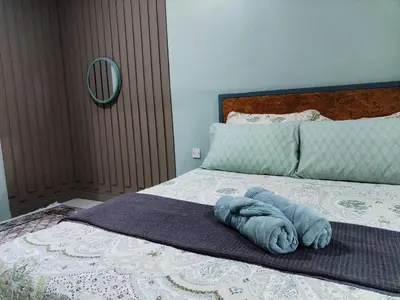 a blue towel laying on top of a bed at D'mesyar Homestay 3BR Fully airconds in Teluk Intan
