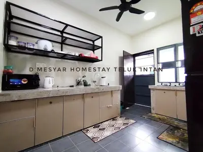 a kitchen with a counter and a ceiling fan at D'mesyar Homestay 3BR Fully airconds in Teluk Intan