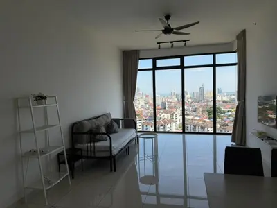 a living room with a chair and a large window at Beacon Executive Suites with Infinity Pool by BNB4U in George Town