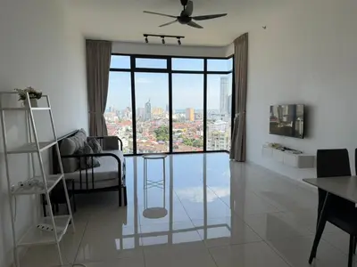 a living room with a ceiling fan and a large window at Beacon Executive Suites with Infinity Pool by BNB4U in George Town