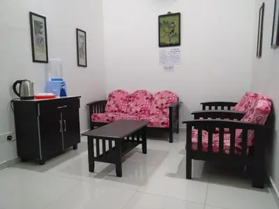a living room with two chairs and a table at Pangkor Villa Jia Yuan \u90a6\u54af\u5c9b\u5bb6\u82d1\u6d77\u6ee9\u522b\u5885 in Pangkor