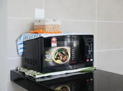 a microwave on top of a shelf in a kitchen at 2Br Sunway Onsen Suit 5 Pax in Tambun