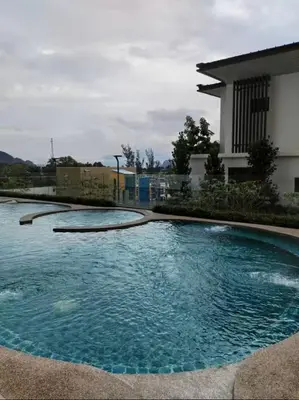a large pool of water in front of a house at 2Br Sunway Onsen Suit 5 Pax in Tambun