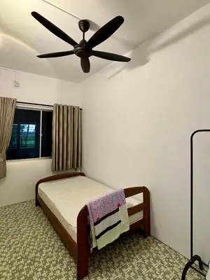 a bedroom with a bed with a ceiling fan at Grace Homestay Taiping in Taiping