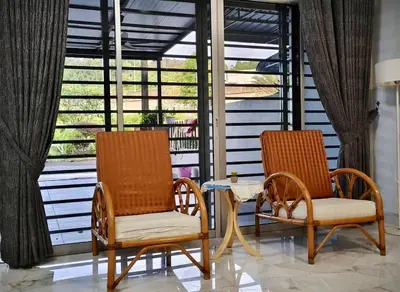 two chairs and a table on a porch at Grace Homestay Taiping in Taiping