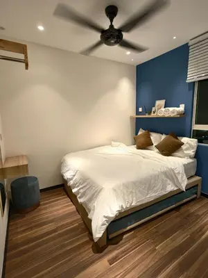 a bedroom with a bed with a ceiling fan at Domuss Guesthouse- 4B3B Tunas in Bayan Lepas