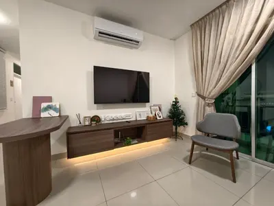 a living room with a television and a chair at Domuss Guesthouse- 4B3B Tunas in Bayan Lepas