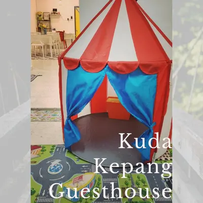 a book about a circus tent on a rug at Kuda Kepang Guesthouse in Sungai Petani