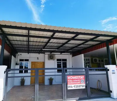 a building with awning in front of a house at Kuda Kepang Guesthouse in Sungai Petani