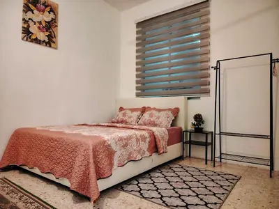 a bedroom with a bed and a window at Kuda Kepang Guesthouse in Sungai Petani