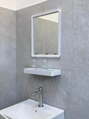 a bathroom with a sink and a mirror at Capy House Taiping in Taiping