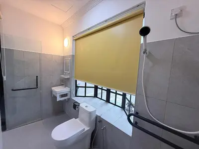 a bathroom with a white toilet and a window at Capy House Taiping in Taiping