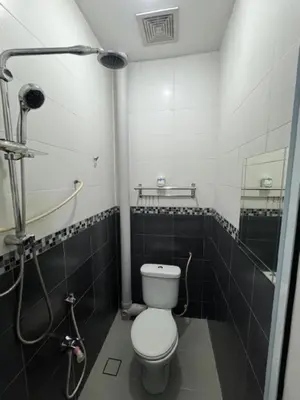 a bathroom with a toilet and a shower at D' Mutiara Homestay in Simpang Ampat
