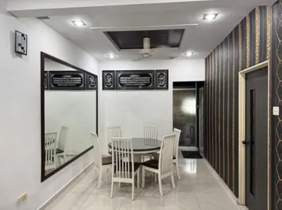 a dining room with a table and chairs at D' Mutiara Homestay in Simpang Ampat
