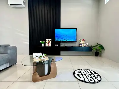 a living room with a tv and a glass table at 4BR Cozy Villa for 16 Pax Quiet Area & Spacious in Simpang Ampat