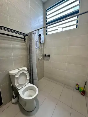 a bathroom with a toilet and a shower with a window at 4BR Cozy Villa for 16 Pax Quiet Area & Spacious in Simpang Ampat
