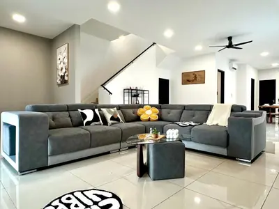 a living room with a couch and a table at 4BR Cozy Villa for 16 Pax Quiet Area & Spacious in Simpang Ampat
