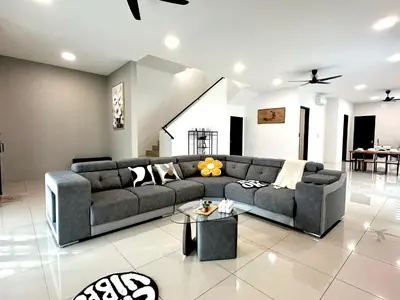 a living room with a couch and a table at 4BR Cozy Villa for 16 Pax Quiet Area & Spacious in Simpang Ampat