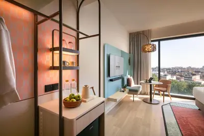 a room with a living room with a couch and a table at Capri by Fraser, Penang in George Town