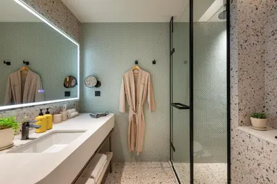 a bathroom with a shower and a sink at Capri by Fraser, Penang in George Town