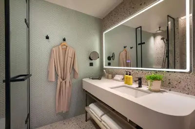 a bathroom with a sink and a mirror at Capri by Fraser, Penang in George Town