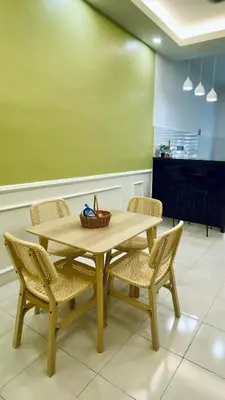 a wooden table and chairs with a basket on it at UHhomestay in Kampong Tok Bedu