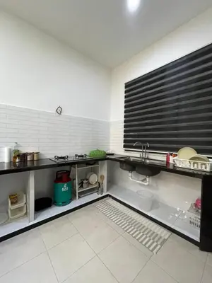 a kitchen with a sink and a counter top at UHhomestay in Kampong Tok Bedu