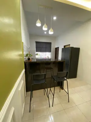 a kitchen with a table and chairs in a room at UHhomestay in Kampong Tok Bedu