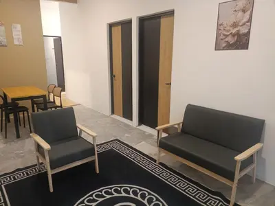 a waiting room with two chairs and a table at Ipoh budget house in Ipoh