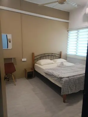 a bedroom with two beds and a window at Ipoh budget house in Ipoh