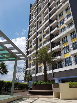 a tall building with a palm tree in front of it at Homii Ipoh CBD in Ipoh