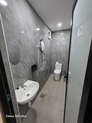 a bathroom with a shower and a sink and a toilet at Bliss Homestay in Simpang Ampat