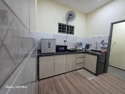 a kitchen with a sink and a counter top at Bliss Homestay in Simpang Ampat
