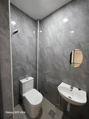 a bathroom with a white toilet and a sink at Bliss Homestay in Simpang Ampat