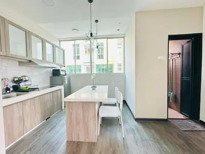 a kitchen with a table and chairs in it at Homestay Golden Hills Apartment Penthouse in Brinchang