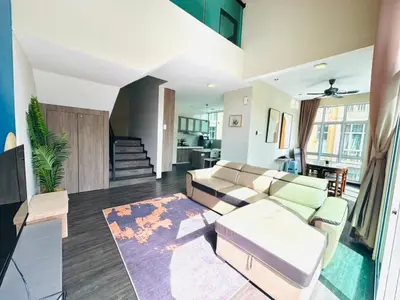 a living room with a couch and a table at Homestay Golden Hills Apartment Penthouse in Brinchang