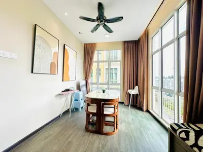 a living room with a ceiling fan and a table at Homestay Golden Hills Apartment Penthouse in Brinchang