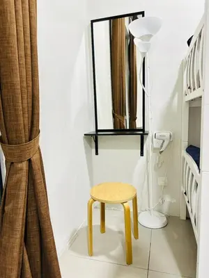 a small stool in a room with a mirror at Homestay Golden Hills Apartment Penthouse in Brinchang
