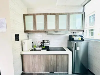 a kitchen with a sink and a refrigerator at Homestay Golden Hills Apartment Penthouse in Brinchang