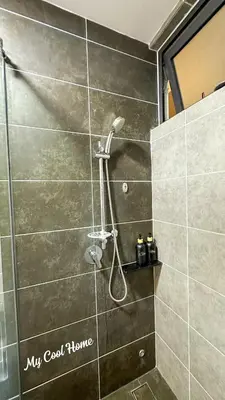a shower with a shower head in a bathroom at Sunway Onsen Suite Theme Park View 2BR in Ipoh
