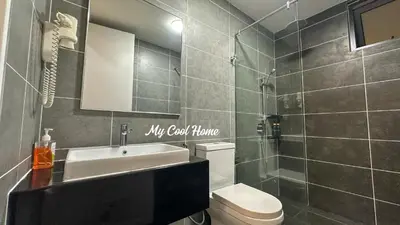 a bathroom with a toilet and a sink and a shower at Sunway Onsen Suite Theme Park View 2BR in Ipoh