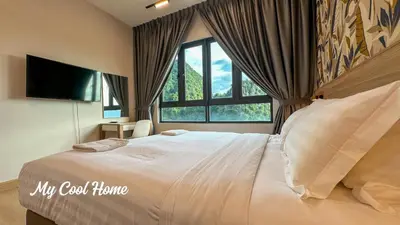 a bedroom with a large bed and a large window at Sunway Onsen Suite Theme Park View 2BR in Ipoh