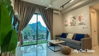 a living room with a couch and a large window at Sunway Onsen Suite Theme Park View 2BR in Ipoh