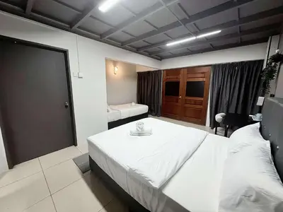 a bedroom with a large white bed in a room at Gather lnn in George Town